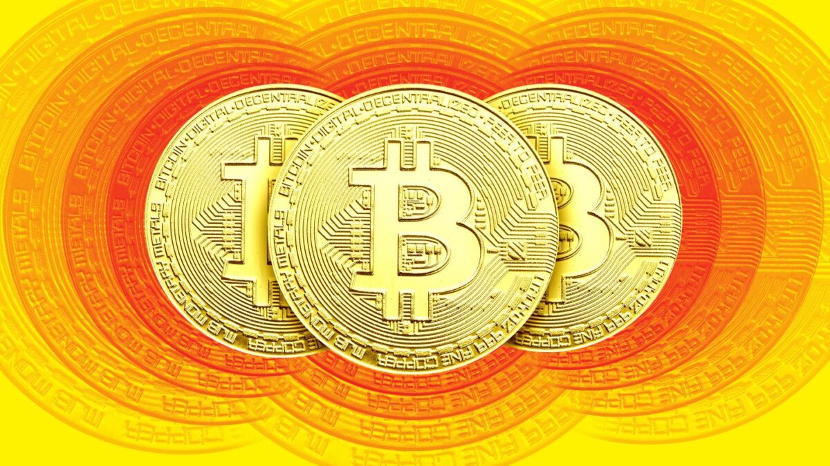 Three Bitcoins disappearing into view.