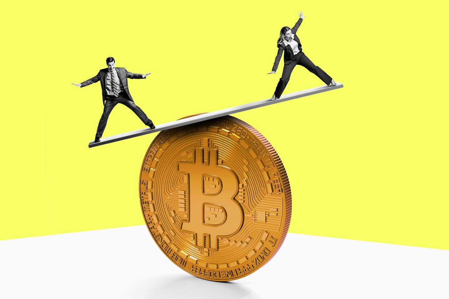 Two people balance on top of a Bitcoin.