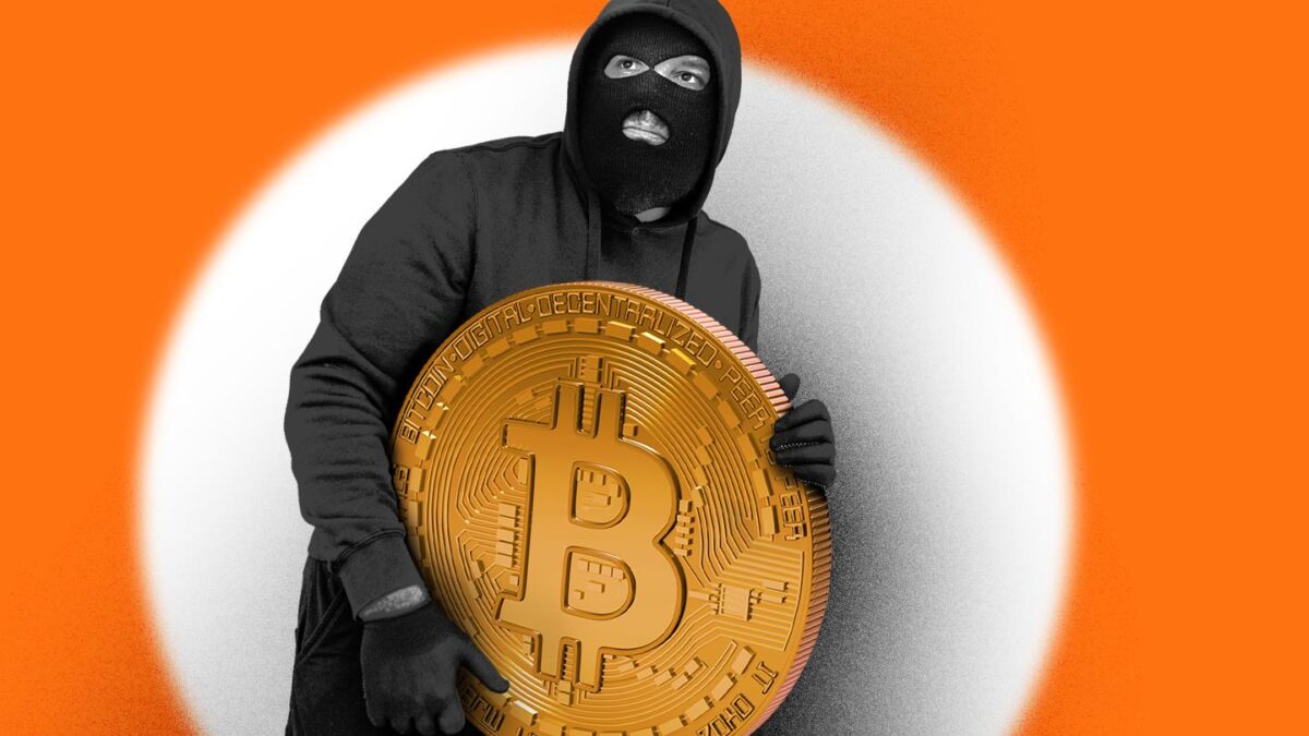 Illustration of a masked man holding a large Bitcoin.