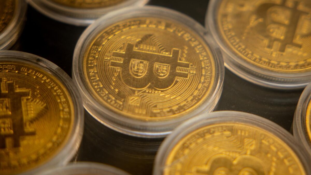 picture of gold coins with bitcoin logo on it