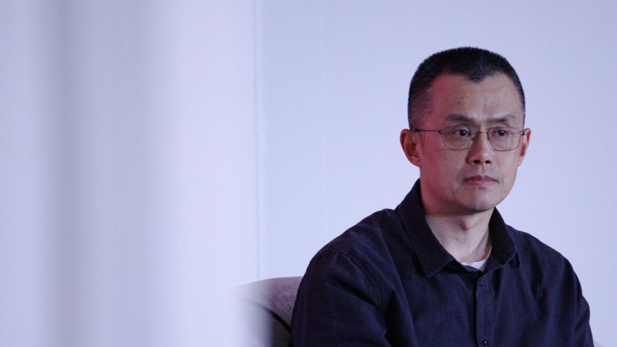 Changpeng Zhao looks of camera in front of blank wall.