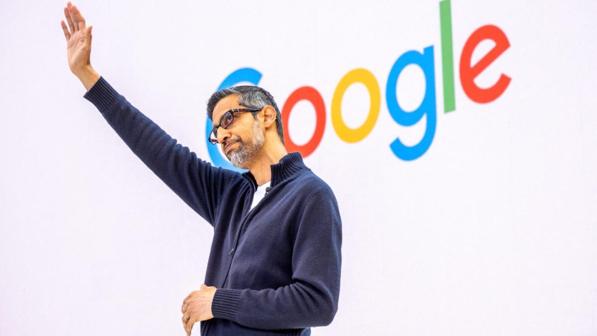 Google CEO waves on stage at a May conference.