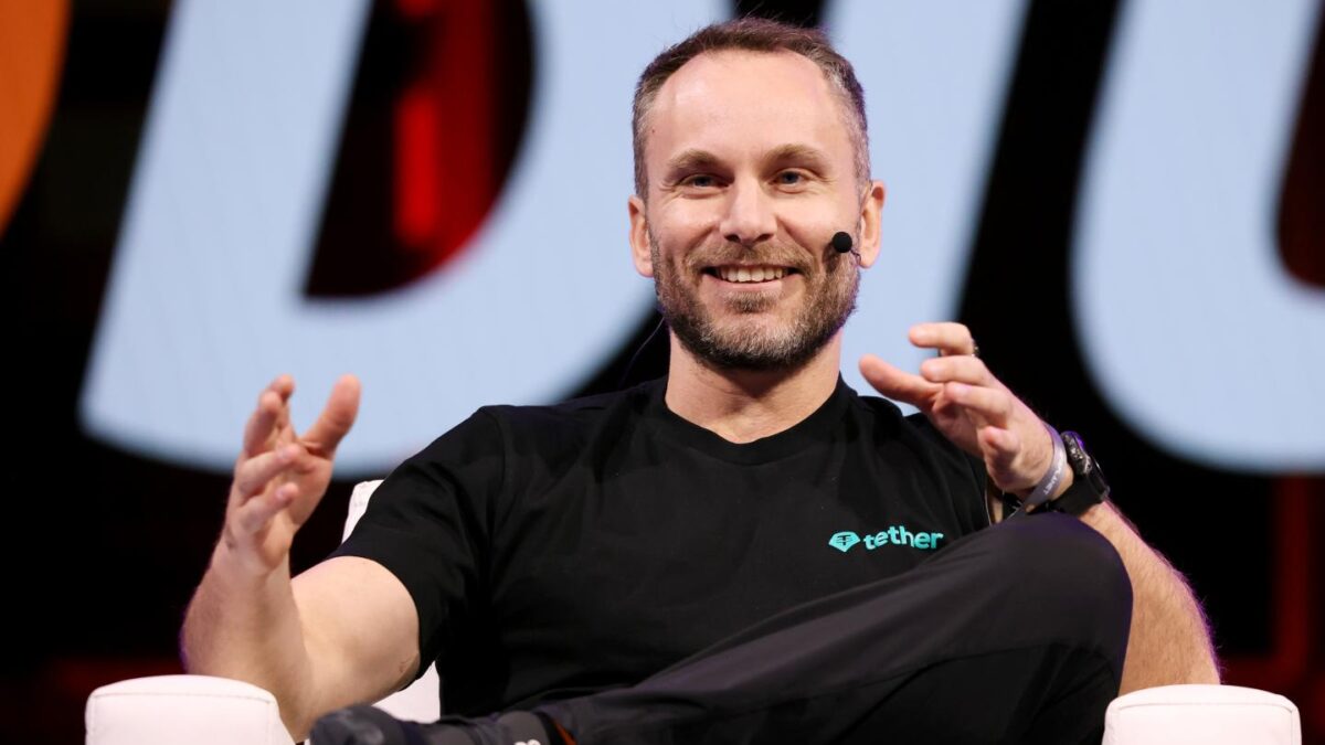 Paolo Ardoino speaks on stage at a Bitcoin conference.