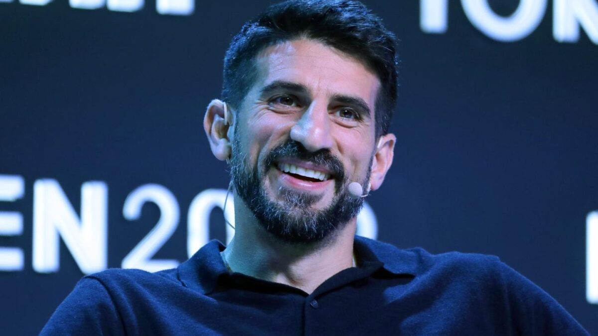 Man smiles in front of camera