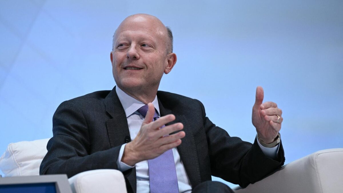 Man in a suit speaks while sitting