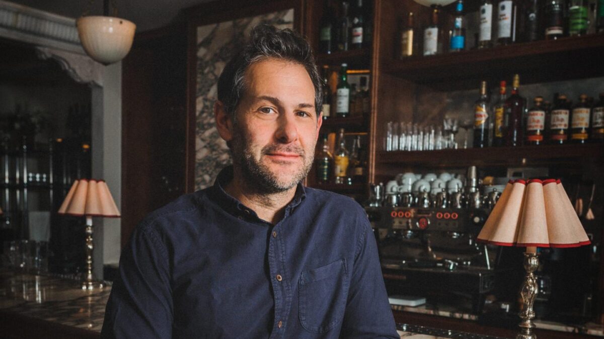 Ben Leventhal sits for a portrait inside a restaurant.
