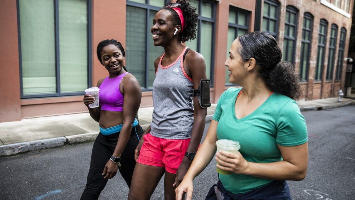 Three female runners walking after a workout