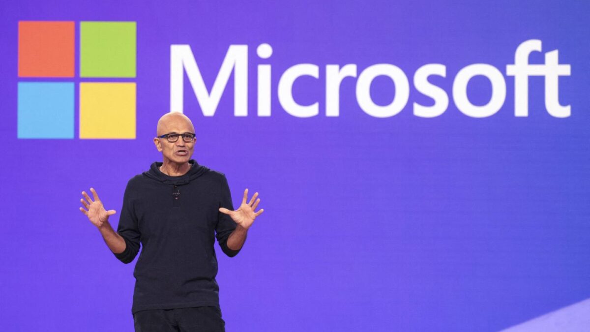 Microsoft CEO Satya Nadella speaks at the Microsoft Build conference in Seattle this year in front of a screen displaying the Microsoft logo.