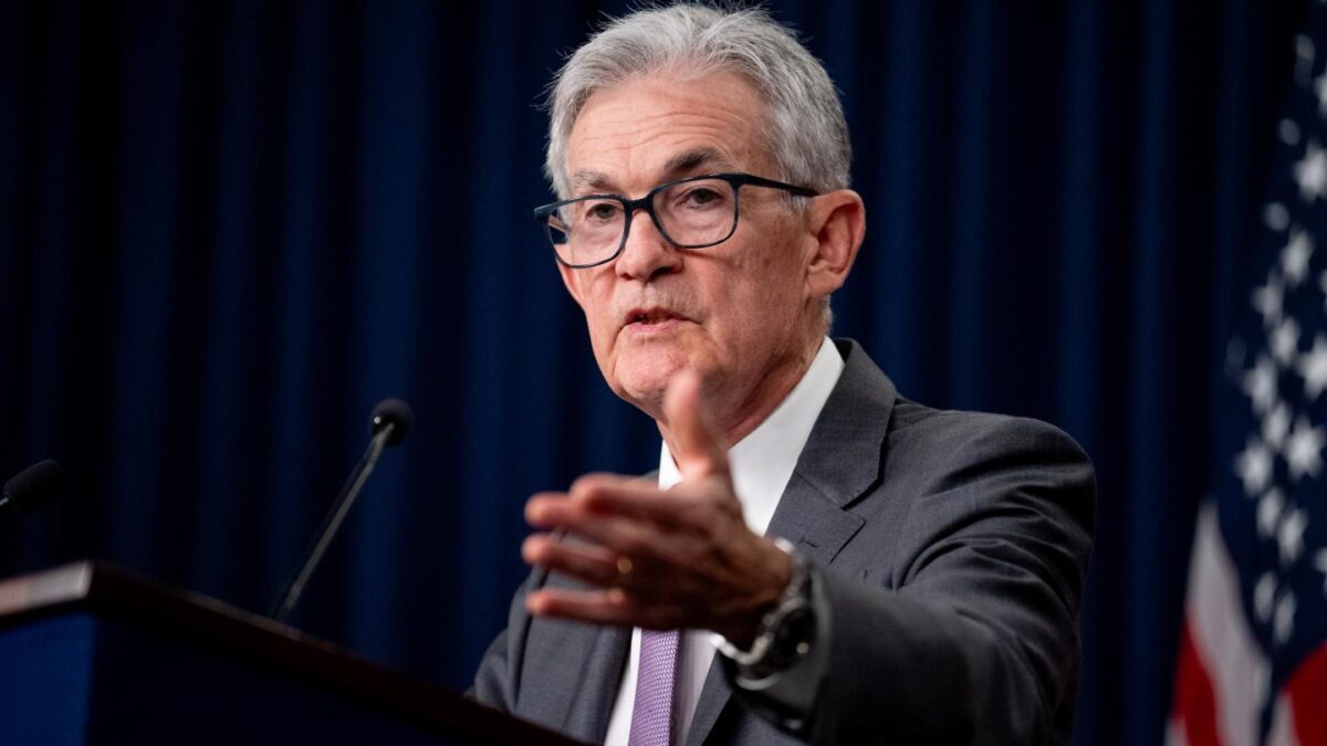 Chair of the Federal Reserve, Jerome Powell, stands at a podium to give a speech on July 31