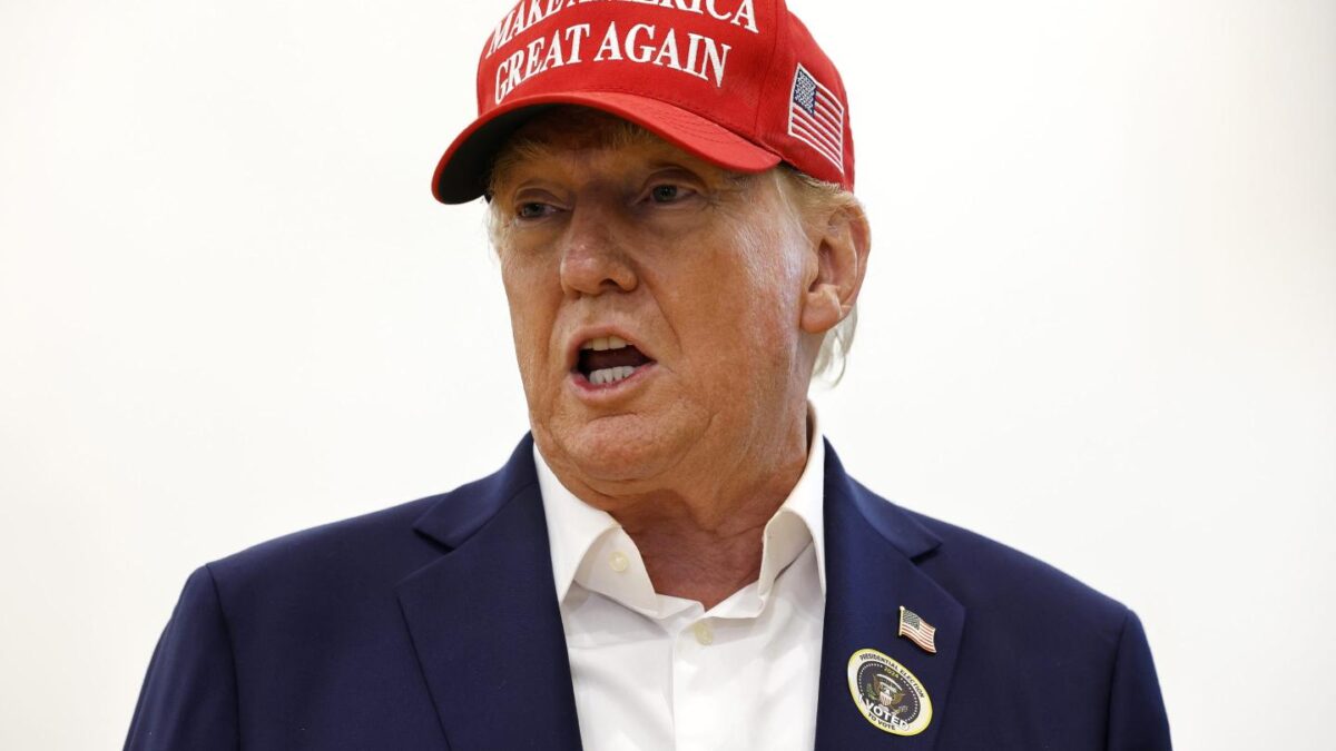 Republican candidate Donald Trump talks to reporters at a polling place in Palm Beach.