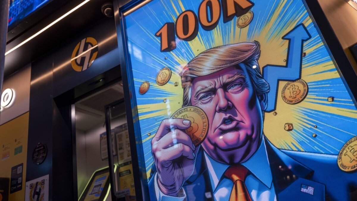 A cartoon image of US President-elect Donald Trump holding a Bitcoin token to mark the cryptocurrency reaching over $100,000