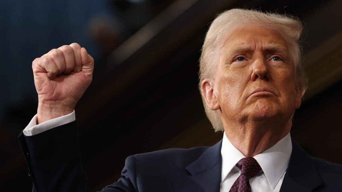 President Donald Trump raises his right hand into a fist.